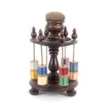 A large mahogany reel stand, the turned circular base on three turned feet to a central baluster