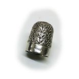 A rare English 'Peter Pan' silver thimble, decorated with leaves and flower heads, the frieze