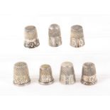 Seven American white metal thimbles, including two Simon Bros. and Co. examples, one engraved with