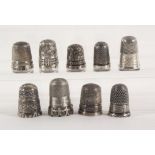 Nine English silver thimbles, comprising three with James Walker raised inscriptions, two with