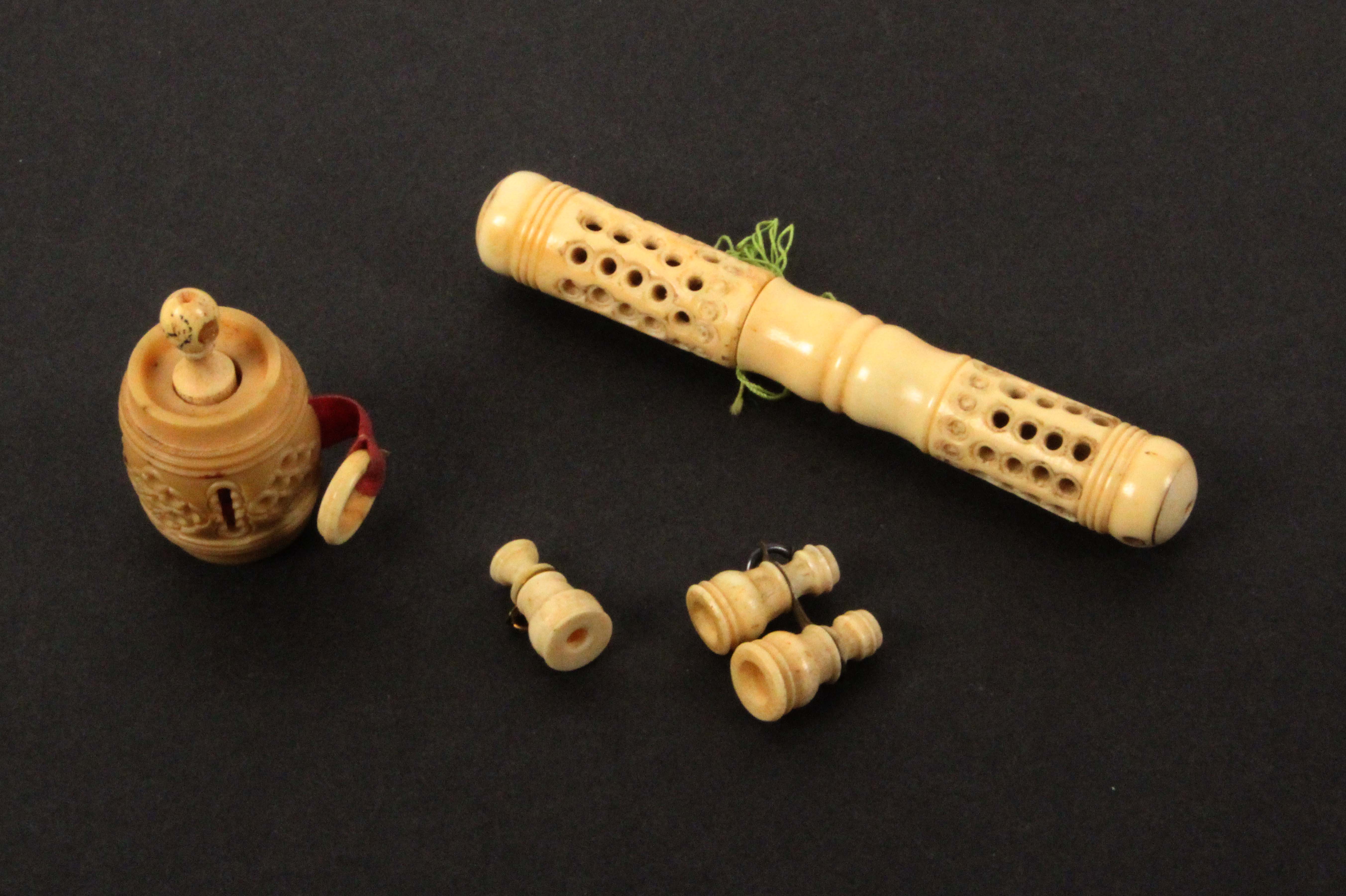 Four bone and vegetable ivory pieces incorporating Stanhopes, comprising a pierced cylinder needle