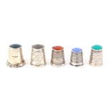 Five stone top English silver thimbles, two by James Swann and Son. (5) From the collection of Roy