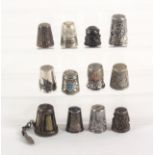 Twelve foreign silver thimbles, including an Arab Marsh niello decorated example, a chained example,