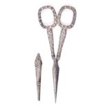 A good pair of silver mounted scissors with sheath, the oval tapering blades to cornucopia style