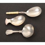 Three silver caddy spoons, comprising an oval bowl example with curved handle, London 1807, makers
