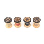 A set of four Tunbridge ware rosewood reel tops, each with circular variant stick ware top and