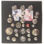 A display of twenty eight mostly silver or white metal buttons, including four English hall marked