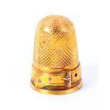 A Victorian gold thimble, the frieze in the form of a belt and buckle. From the collection of Roy