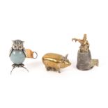 Three metal novelty tape measures, comprising an example in the form of a thimble surmounted by a