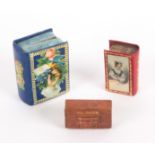 Three needle packet boxes, comprising a gilt tooled red leather book form example, the lid with