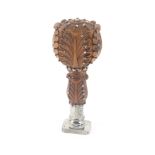 A fine French carved walnut and cloute work desk seal, leaf carved handle and stem to a steel mount,