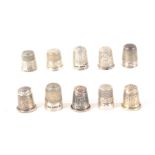 Ten English hall marked or stamped silver thimbles, some with decorative friezes or bodies. (10)