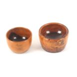 Two 19th Century turned lignum vitae wool ball bowls, 8.7 and 7.5cms dia. (2)