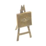 A polished brass Avery needle packet case 'Easel', floral, easel re-soldered to folio, 12cms high.