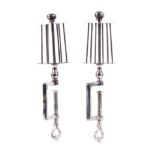 A pair of polished steel winding clamps, the rectangular frames with heart pierced screw