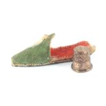 An early 19th Century miniature thimble for a doll in slipper form case, the copper gilt thimble