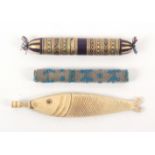 Three needle cases, comprising a carved bone fish form example with screw end cap, 12cms, a beadwork