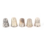 Five attractive English silver thimbles, all hall marked including two with pierced friezes. (5)