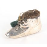 A silver pin cushion in the form of a baby's boot, with tasselled laces, Birmingham 1919, 'Rd
