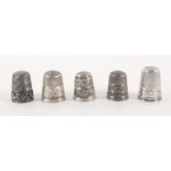 Five English silver thimbles, comprising a raised letter example 'Reading', another 'Isle of Man'