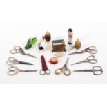 A mixed lot - sewing, comprising eight pairs of scissors including a pair with silver handles, 9cms,
