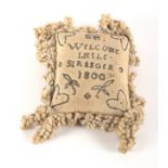 A layette rectangular linen pin cushion, inscribed in pins 'EB Welcome Little Stranger 1800', amid