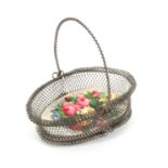 A 19th Century wire mesh miniature basket, with swing handle, the oval base with raised colour print