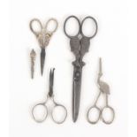 Four pairs of scissors, comprising a pair with floral silver arms to bound oval wreath loops,