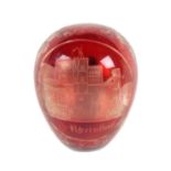 A good 19th Century ruby glass overlay etched glass darning egg, with an oval cut panel of a