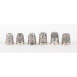 Six English thimbles, comprising a Henry Griffiths and Son silver example - Royal Spa, a Walker