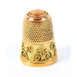 A 9ct gold thimble, the frieze decorated with wire work and dots arranged in circles and scrolls,