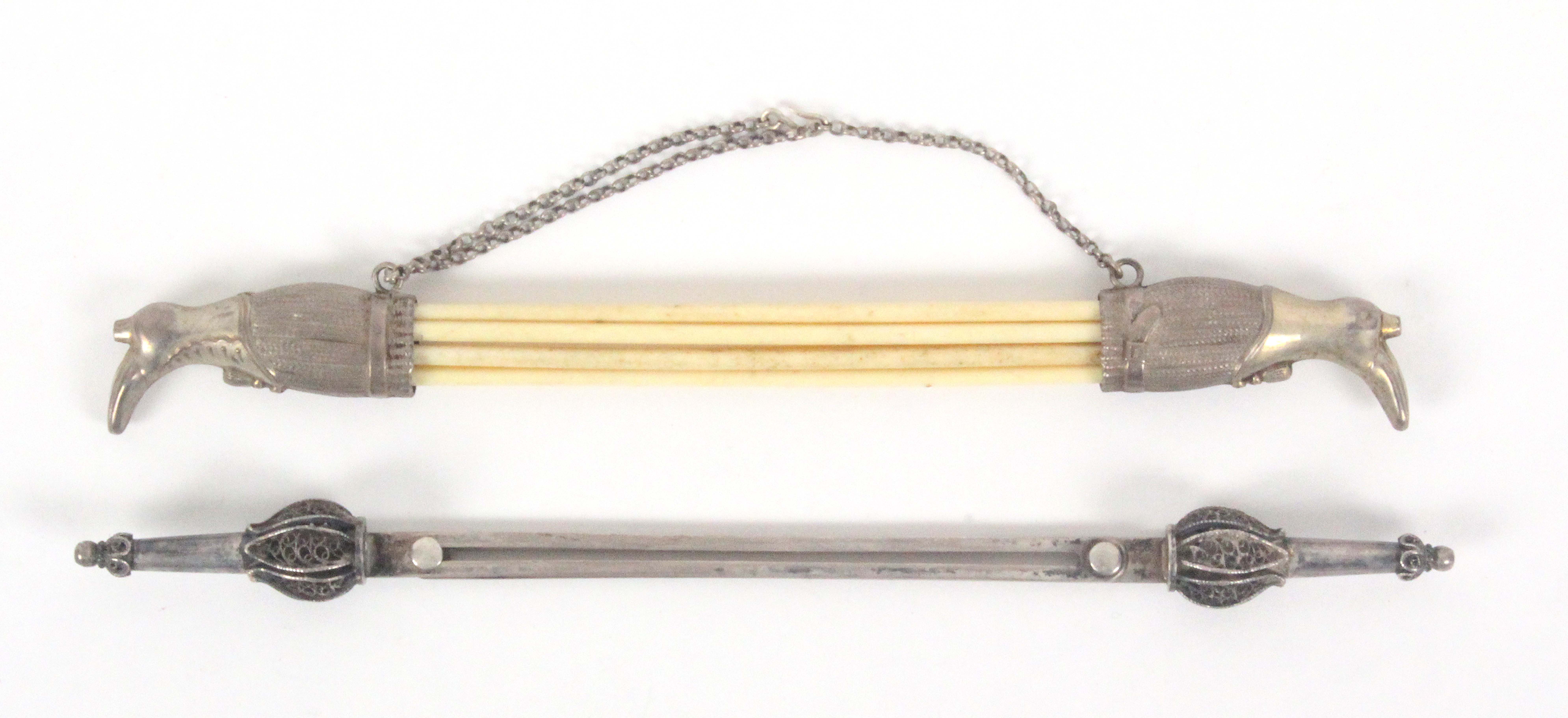 Two German silver knitting needle retainers, comprising a chained pair in the form of lady's boots
