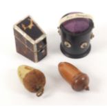 Three pin cushions and a thimble case, comprising an ebony bucket form bone mounted pin cushion, the