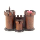 A rosewood castle gateway sewing companion, one turret as a pin cushion, the other a tape measure (