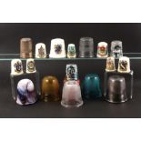 A collection of over sized thimbles, comprising four glass 'Just A Thimble Full' measures, largest