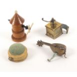 Four novelty tape measures, comprising a brass example in the form of a coffee grinder with complete