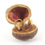 A miniature etui for a child or doll housed in a natural walnut, with decorated gilt hinge mount,