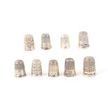 Nine English hall marked silver thimbles, most with decorative friezes. (9) From the collection of