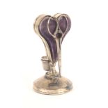 An unusual heart shaped silver standing pin cushion incorporating stands for thimble and scissors,