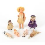 Seven small dolls, 19th Century and later, comprising five with ceramic elements, two clothed,