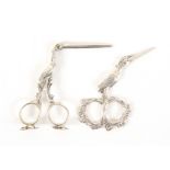 Two pairs of Dutch stork form silver scissors, comprising a pair of ribbon scissors each loop