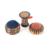 Tunbridge ware - three pieces, comprising two circular stick ware pin cushions, one raised on