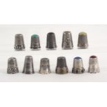 Eleven continental silver thimbles, German and French, including five with stone tops and decorative