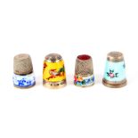 Four enamel decorated silver thimbles, comprising a bird and flower decorated example by James Swann