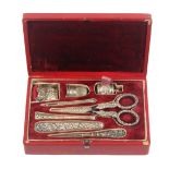 A red leather cased silver sewing set attributed to Joseph Taylor and dated to the lid plaque 'Dec