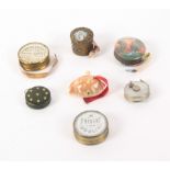 Seven tape measures, comprising a natural shell example with complete printed tape, 4.5cms, two