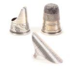 Three 19th Century silver thimbles, comprising a Dutch thimble ring with ribbed face, a steel topped