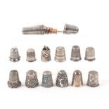 Twelve silver thimbles and a thimble compendium, the last of two section form the thimble with green