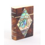 A tortoiseshell and abalone shell needle packet case, in the form of a 'book', divided 'spine',