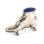 A scarce silver pin cushion in the form of a shoe and roller skate, Birmingham 1910, makers mark